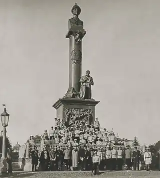Tourists at the monument to the peasant Ivan Susanin and Tsar Mikhail Romanov